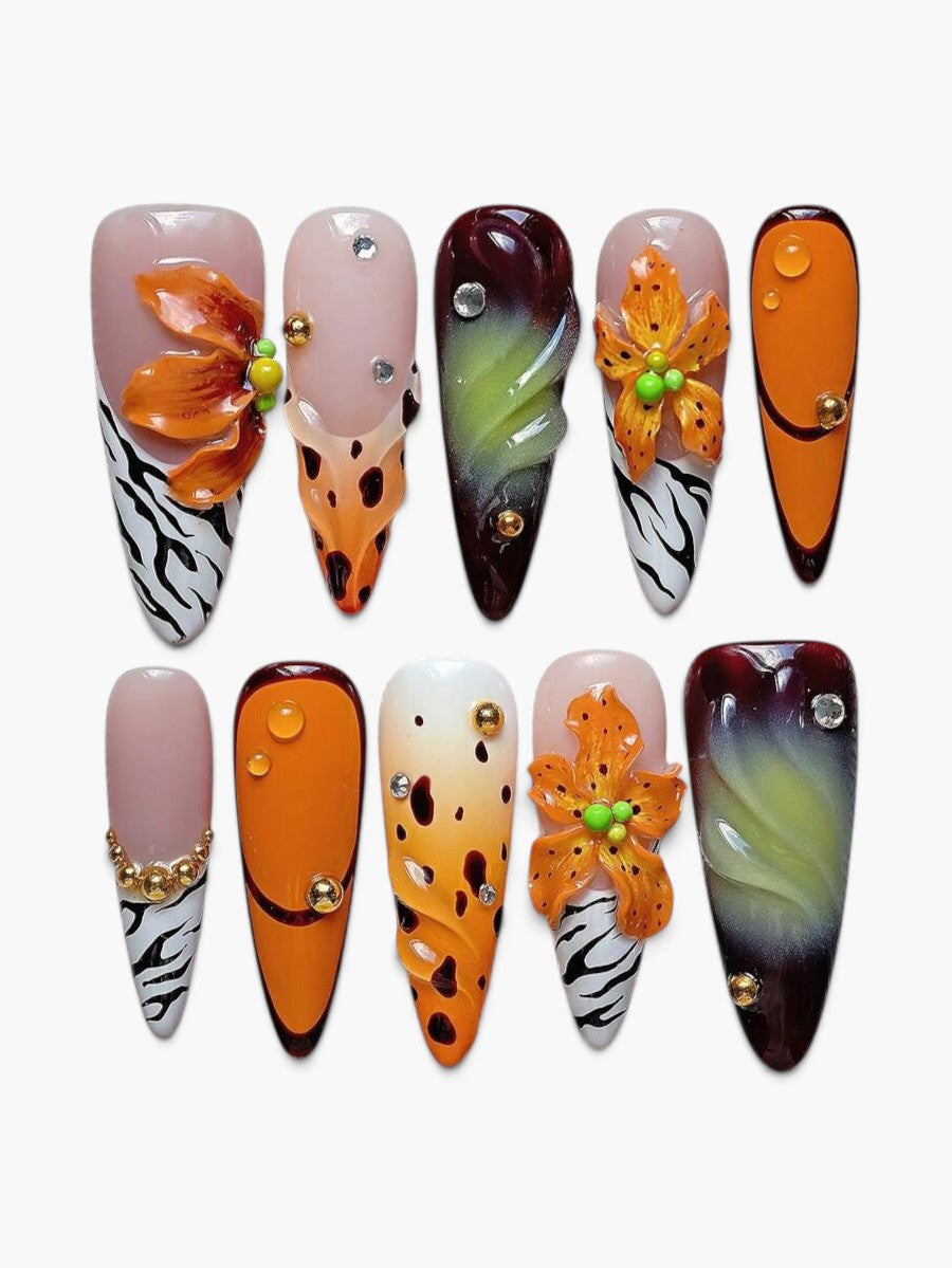 Faux ongles Cherry Rouge longs en amande, multicolores avec motifs floraux, zébrés et détails en relief brillants.