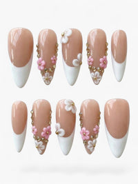 Manucure Cherry Rouge Crystal Bloom en forme amande, gel beige et blanc avec fleurs en relief et détails vitreux.