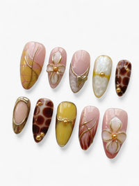 Set de faux ongles Cherry Rouge Savage Elegance en forme amande avec motifs graphiques nude, noir et détails dorés