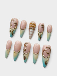 Manucure Cherry Rouge Gilded Tides en forme amande avec dégradé bleu, détails dorés en relief et finitions brillantes