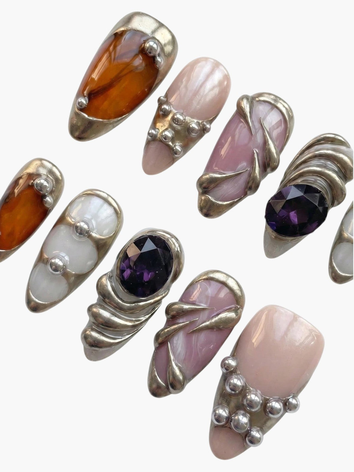 Manucure Cherry Rouge Violet Mirage en forme amande avec dégradés violets, reflets nacrés et détails argentés sculptés